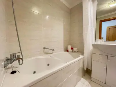 a white bath tub in a white bathroom at Suite Elizabeth in Funchal
