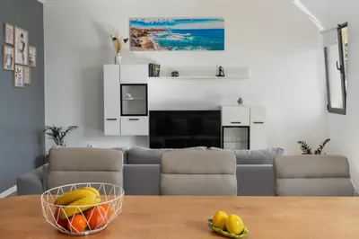 a living room with a bowl of fruit on a table at Casa Jorge Calaça by An Island Apart in Caniçal