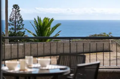 a table and chairs with a view of the ocean at Casa Jorge Calaça by An Island Apart in Caniçal