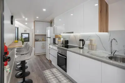 a white kitchen with a sink and a counter top at Casa Jorge Calaça by An Island Apart in Caniçal