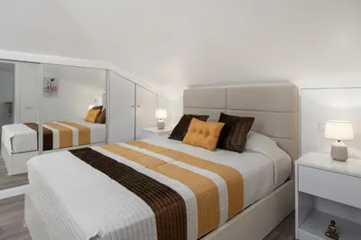 a white bedroom with two beds and a mirror at Casa Jorge Calaça by An Island Apart in Caniçal