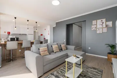 a living room with a couch and a kitchen at Casa Jorge Calaça by An Island Apart in Caniçal