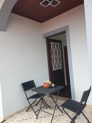 a table and two chairs in front of a door at Silva House in Ribeira Brava