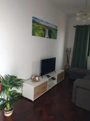 a living room with a flat screen tv on a table at Silva House in Ribeira Brava