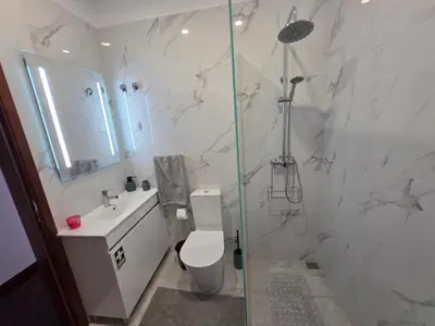 a bathroom with a shower and a toilet and a sink at Silva House in Ribeira Brava