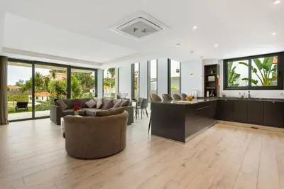a living room with a couch and a tv at Casa Jolie in Ponta do Sol