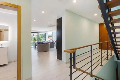 a staircase in a house with a living room at Casa Jolie in Ponta do Sol