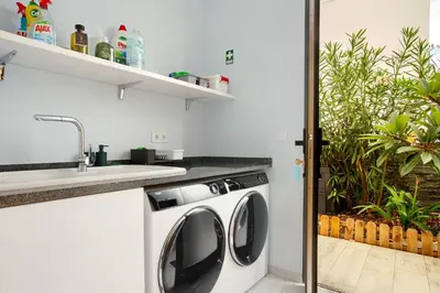 a washing machine in a kitchen next to a sink at Casa Jolie in Ponta do Sol