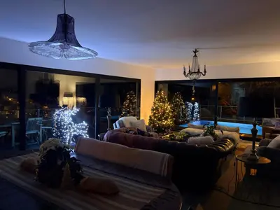 a living room with christmas trees and couches at Tabua Lodge in Ponta do Sol
