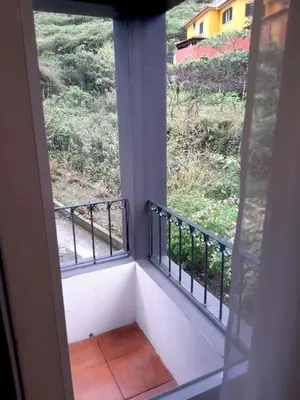 a view from a window of a balcony at Refúgio Guest House in São Vicente
