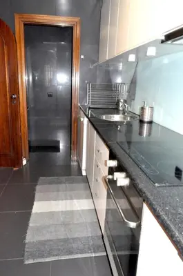 a kitchen with a sink and a counter top at Refúgio Guest House in São Vicente