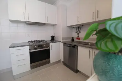 a kitchen with white cabinets and a stove top oven at Aqua City by Farmer's Market in Funchal