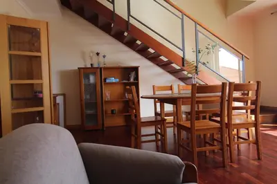 a living room with a table and a staircase at Aqua City by Farmer's Market in Funchal