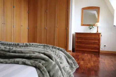 a bedroom with a bed with a dresser and a mirror at Aqua City by Farmer's Market in Funchal