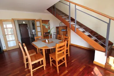 a dining room with a table and chairs and a staircase at Aqua City by Farmer's Market in Funchal