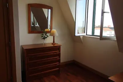 a dresser with a mirror and a lamp in a room at Aqua City by Farmer's Market in Funchal