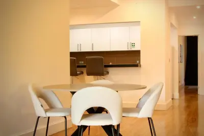 a dining room with a table and chairs at Like Home III - Apartamento com 2 quartos, ideal para famílias e amigos in Funchal