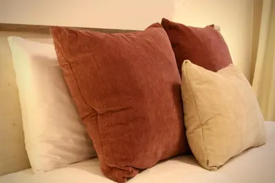 a group of pillows sitting on top of a bed at Like Home III - Apartamento com 2 quartos, ideal para famílias e amigos in Funchal