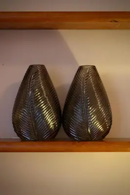two metal vases are sitting on a shelf at Like Home III - Apartamento com 2 quartos, ideal para famílias e amigos in Funchal