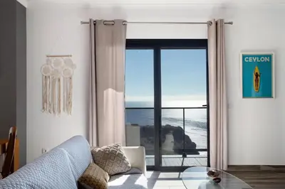 a living room with a view of the ocean at Morning Glory Penthouse in Estreito da Calheta