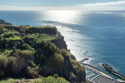 an aerial view of the ocean and a highway at Morning Glory Penthouse in Estreito da Calheta
