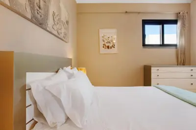 a bedroom with a white bed with white pillows at Morning Glory 2 Bedroom Apartment in Calheta