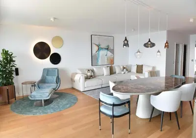 a living room with a couch and a table and chairs at The View residence in Funchal