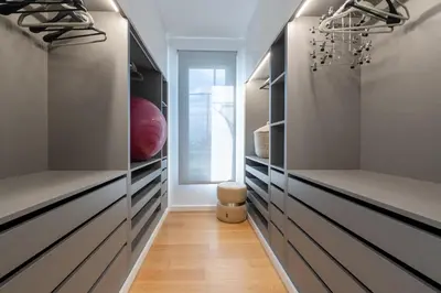 a walk in closet with wooden floors and gray cabinets at The View residence in Funchal