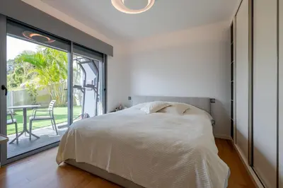 a bedroom with a bed and a large window at The View residence in Funchal