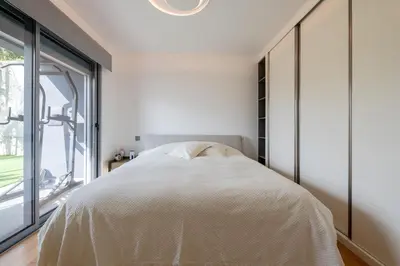 a bedroom with a bed and a large window at The View residence in Funchal