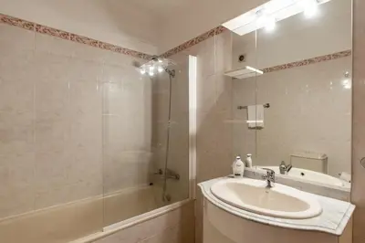 a bathroom with a sink and a shower and a tub at Bela Vale Nº4 in Ribeira Brava