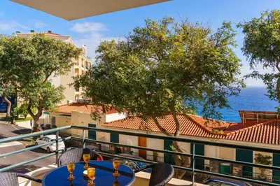 a table on a balcony with a view of the ocean at GuestReady - Ocean-View Retreat in Caniço in Caniço