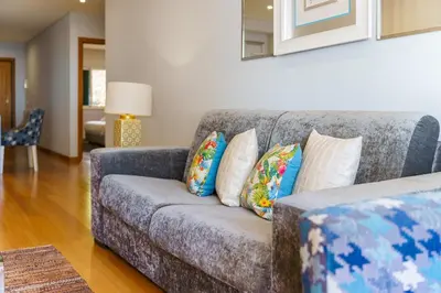 a living room with a gray couch with pillows at GuestReady - Ocean-View Retreat in Caniço in Caniço