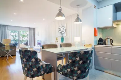 a kitchen and living room with a counter and chairs at GuestReady - Ocean-View Retreat in Caniço in Caniço