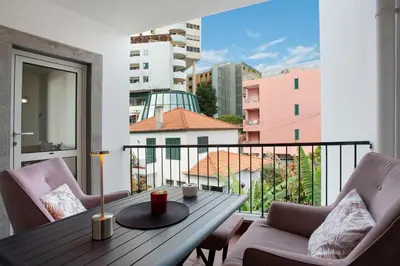 a balcony with a table and chairs and a view at Imperatriz Madeira Apartment in Funchal