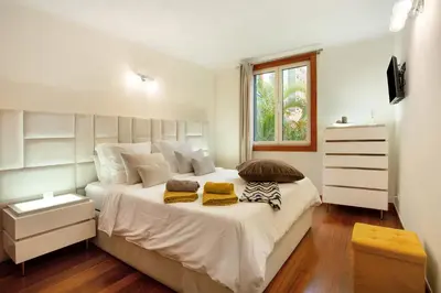 a bedroom with a large white bed with two pillows at Imperatriz Madeira Apartment in Funchal