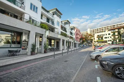 a street with cars parked on the side of the road at Imperatriz Madeira Apartment in Funchal