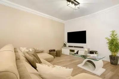 a living room with a couch and a flat screen tv at Imperatriz Madeira Apartment in Funchal