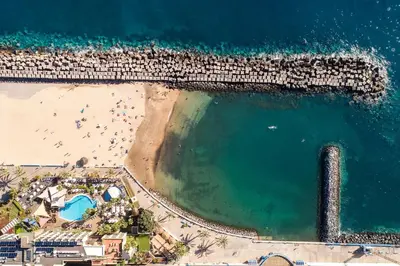 an overhead view of a beach and the ocean at Sunset House in Calheta