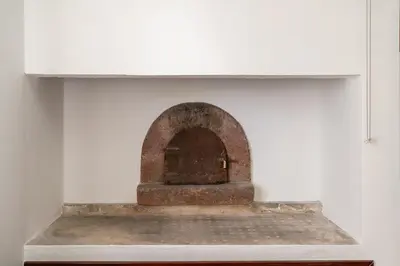 an old brick oven in a white wall at Sunset House in Calheta
