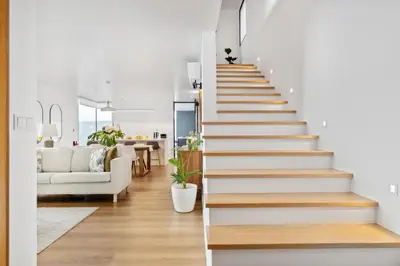 a staircase leading up to a living room with a couch at Porto Moniz Atlantic View in Porto Moniz