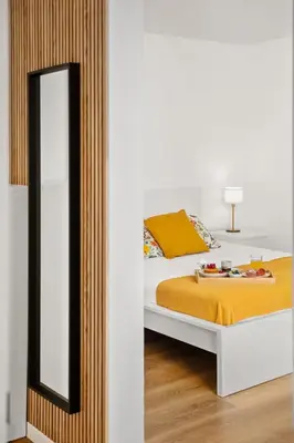 a bedroom with a bed and a mirror at Porto Moniz Atlantic View in Porto Moniz