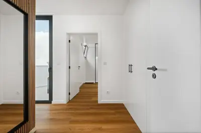 a bathroom with white walls and a mirror at Porto Moniz Atlantic View in Porto Moniz