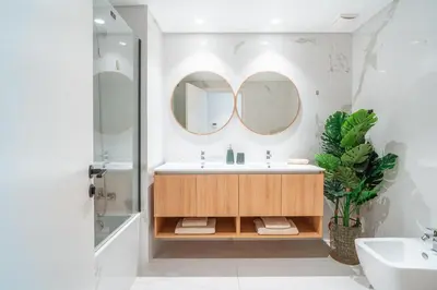 a bathroom with a sink and two mirrors at Suite Q - Supermarket - Pool - AC - Private Parking Spot in Funchal