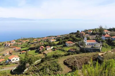 a village on top of a hill with houses at Pôr do Sol I in Porto Moniz