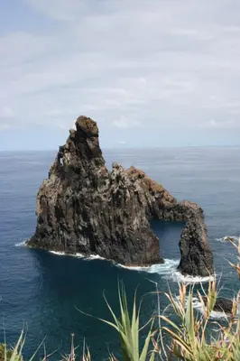 a rock formation in the ocean on the coast at Pôr do Sol I in Porto Moniz