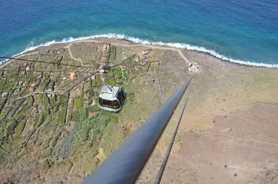 an aerial view of a car parked on the beach at Pôr do Sol I in Porto Moniz