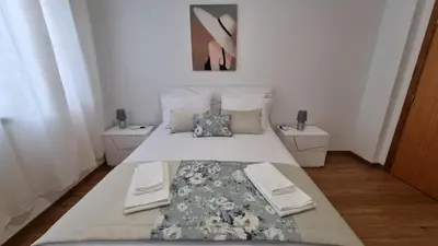 a bedroom with a large bed with two night stands at Pôr do Sol I in Porto Moniz