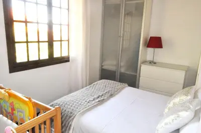 a small bedroom with a bed and a window at Quinta O Refúgio in São Vicente