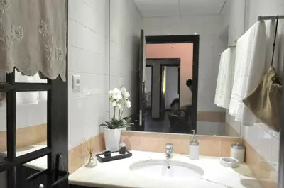 a bathroom with a sink and a mirror at Quinta O Refúgio in São Vicente